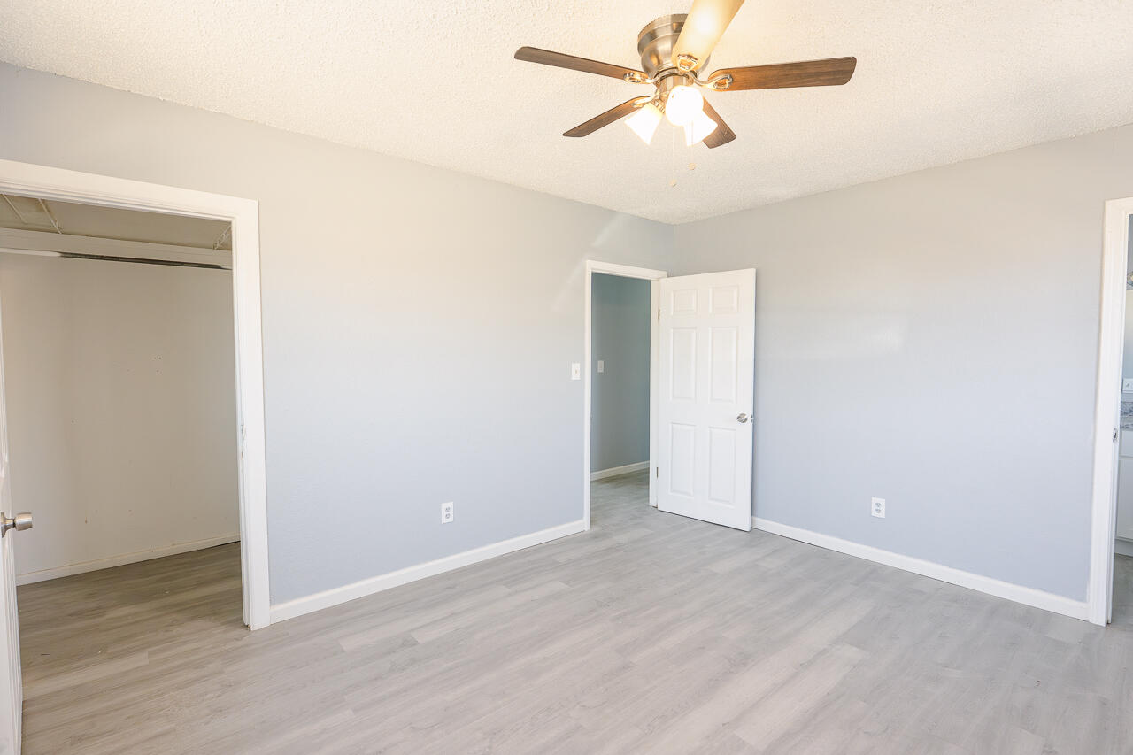 2802 40th Street Lubbock, TX 79413 - Photo 14 of 21 a view of a room with wooden floor and a ceiling fan