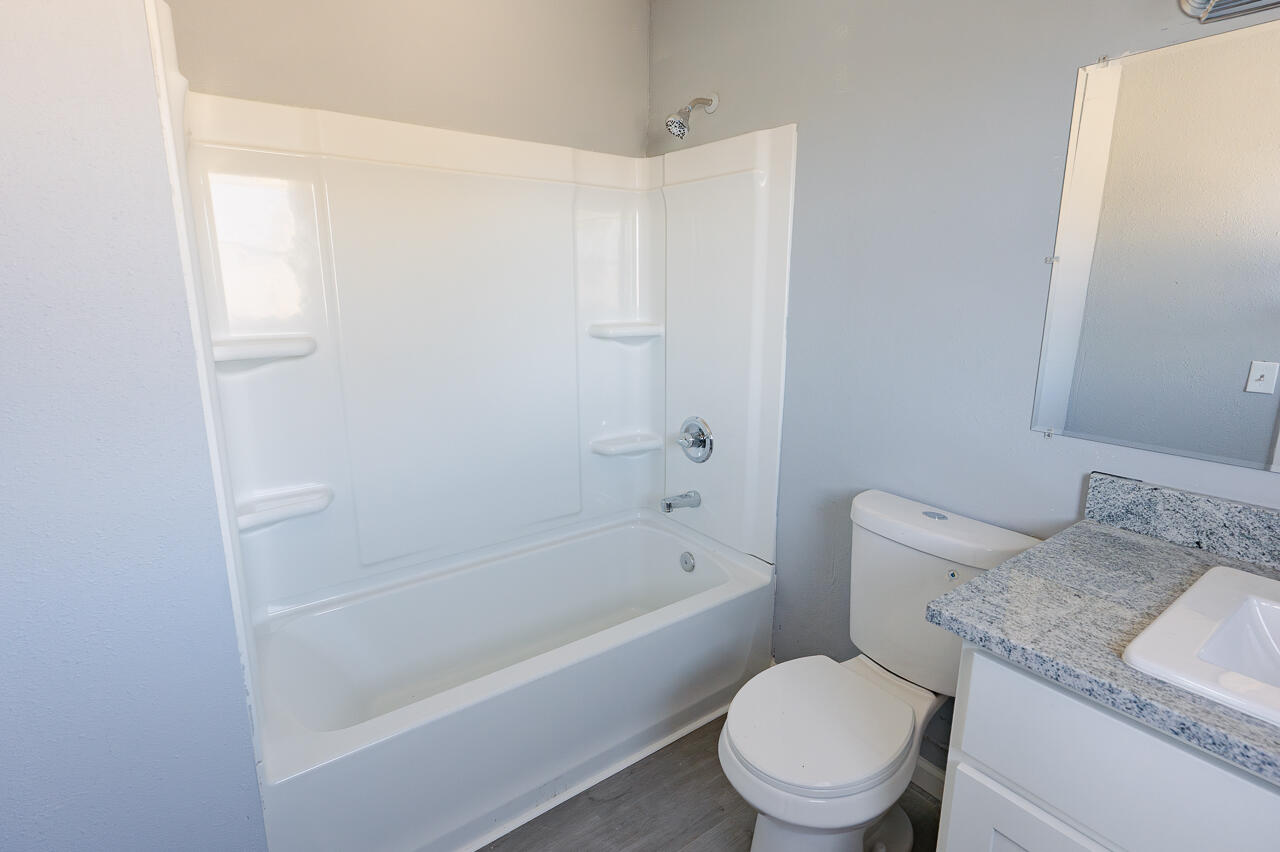 2802 40th Street Lubbock, TX 79413 - Photo 15 of 21 a white toilet sitting next to a bath tub