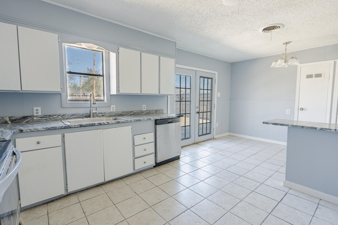 2802 40th Street Lubbock, TX 79413 - Photo 21 of 21 a kitchen with a sink cabinets and window