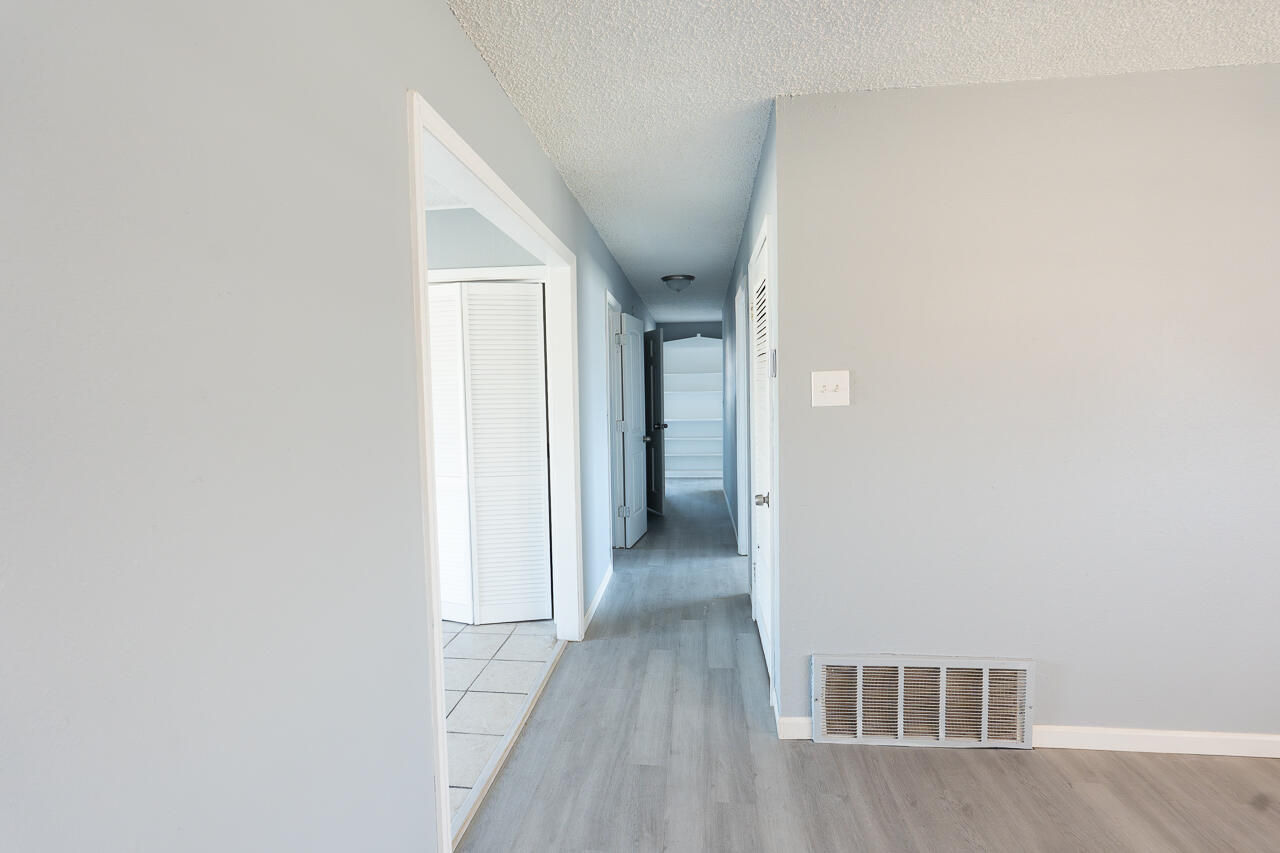 2802 40th Street Lubbock, TX 79413 - Photo 8 of 21 a view of a hallway with wooden floor