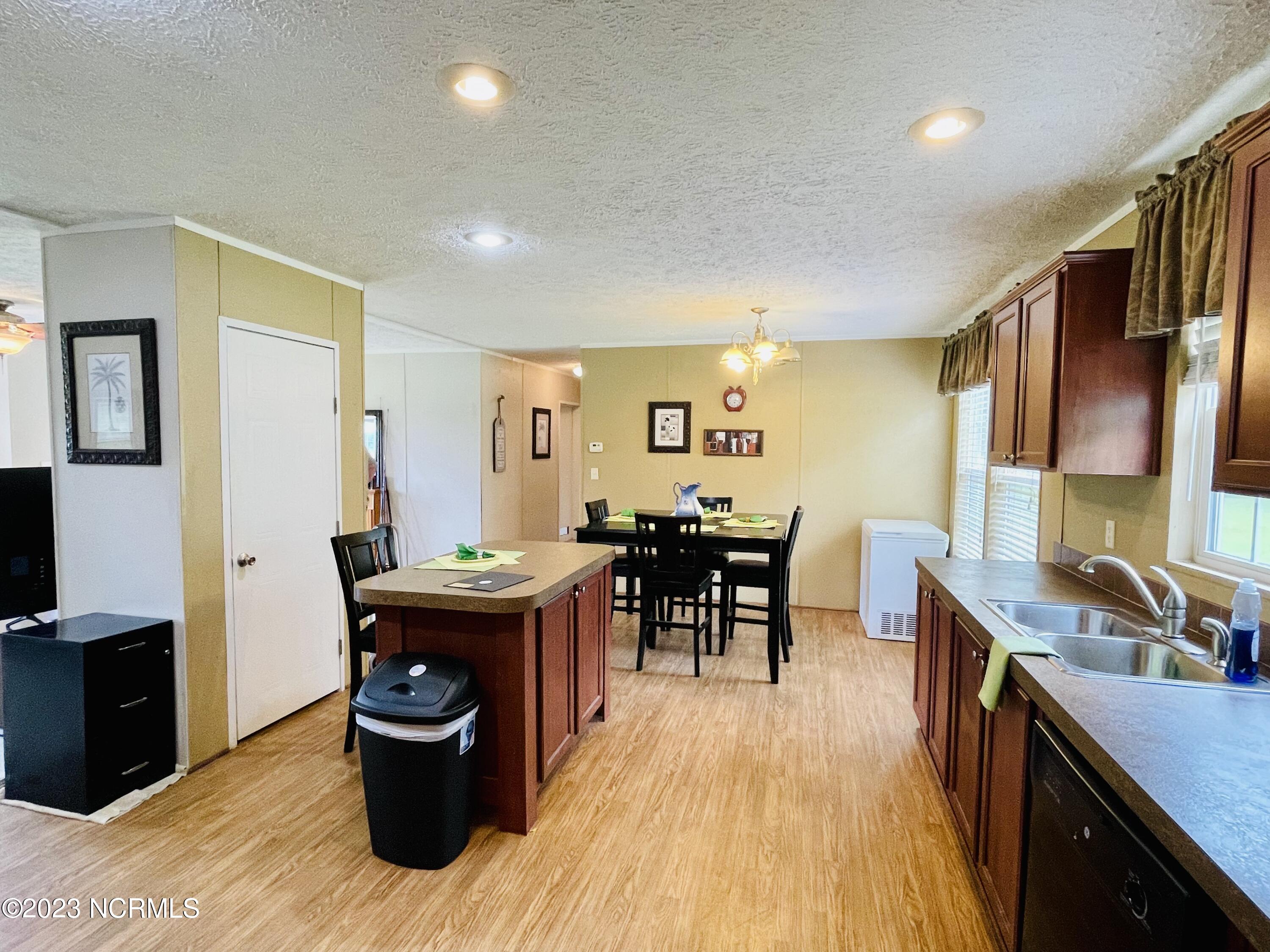 112 Cain Loop Road Elizabethtown, NC 28337 - Photo 6 of 17 Kitchen with Island and pantry with deep freezer