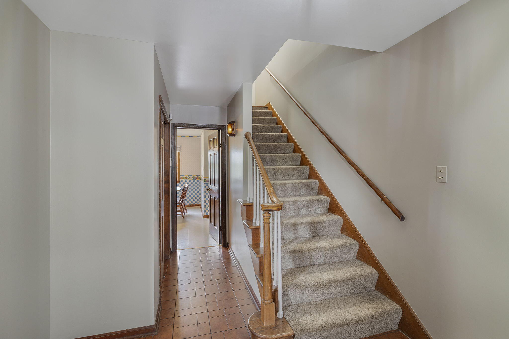 218 West 38th Court Griffith, IN 46319 - Photo 3 of 23 a view of staircase with wooden floor and white walls