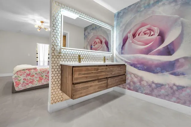 a bedroom with a bed and a painting on the wall