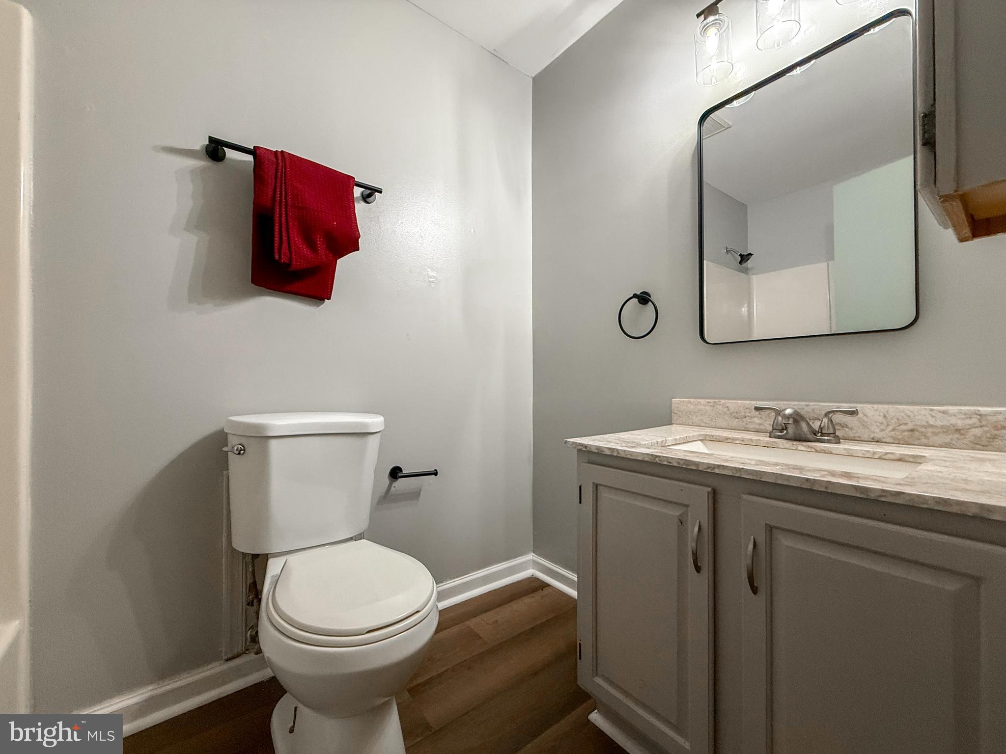 115 Upper Valley Lane Newark, DE 19711 - Photo 19 of 21 a bathroom with a toilet sink vanity and mirror