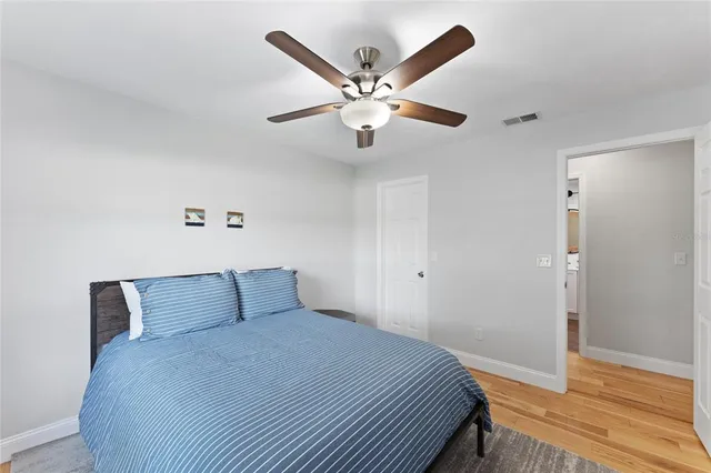 a bedroom with a bed and a ceiling fan