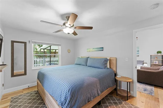a bedroom with a large bed and a chandelier