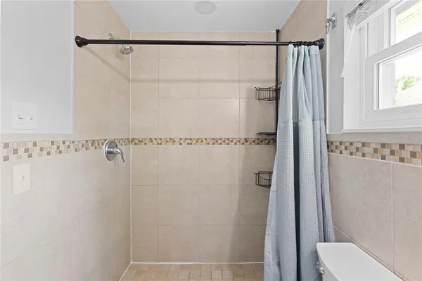 a bathroom with a shower and a toilet