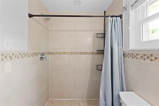 a bathroom with a shower and a toilet