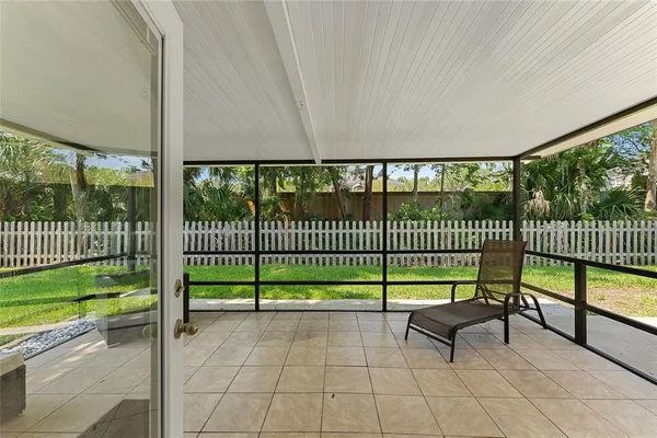 a view of a chair and floor to ceiling window