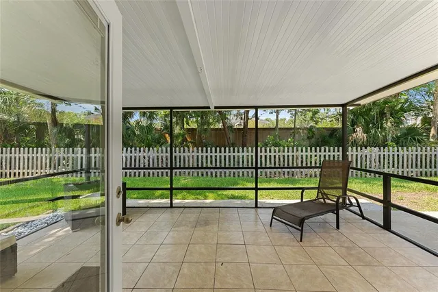 a view of a chair and floor to ceiling window