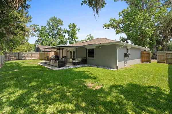 a view of a house with backyard and sitting area