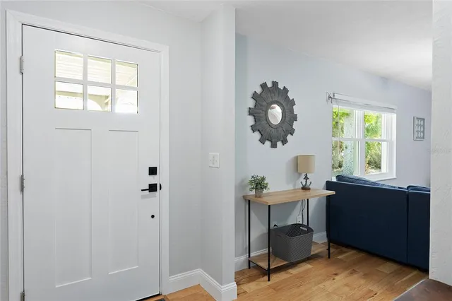 a room with a table chairs and a window