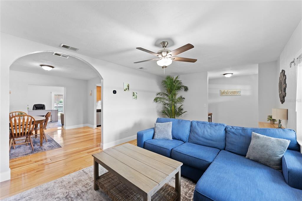 909 Bentwood Lane, Unit 1 Port Orange, FL 32127 - Photo 9 of 36 a living room with furniture potted plant and a window