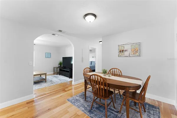 a view of a dining room with furniture and wooden floor