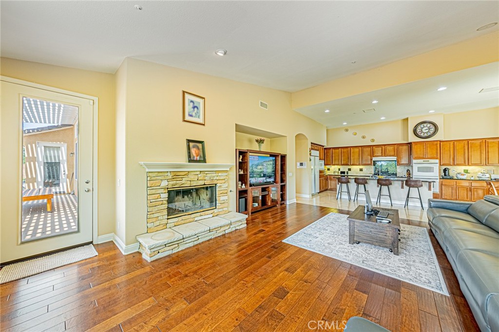 4088 Shady Ridge Circle Corona, CA 92881 - Photo 39 of 47 a living room with furniture and a fireplace with wooden floor