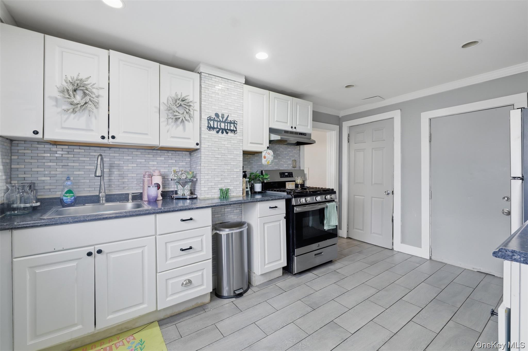 121 Little Britain Road Newburgh, NY 12550 - Photo 7 of 15 a kitchen with white cabinets and appliances