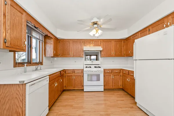 a kitchen with stainless steel appliances granite countertop a stove a sink dishwasher and a refrigerator