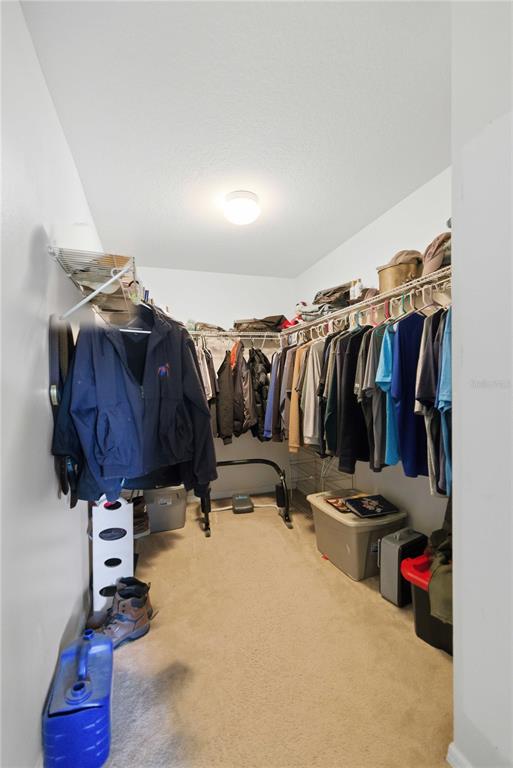 3959 Southwest 129th Street Ocala, FL 34473 - Photo 17 of 27 a view of walk in closet with clothes and shoes