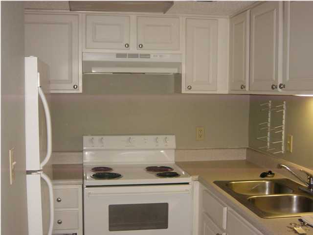 101 Old Ferry Road, Unit 3B Shalimar, FL 32579 - Photo 3 of 6 a kitchen with stainless steel appliances granite countertop a sink stove and refrigerator
