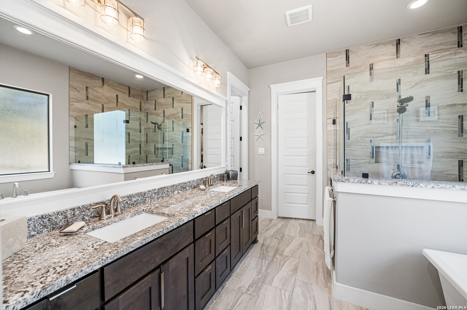 407 Havasu Spring Branch, TX 78070 - Photo 30 of 70 a bathroom with a granite countertop double vanity sink and mirror with shower