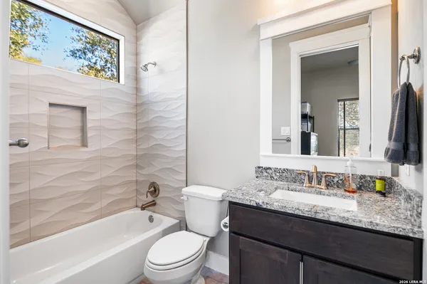 a bedroom with a bed and a flat screen tv with wooden floor