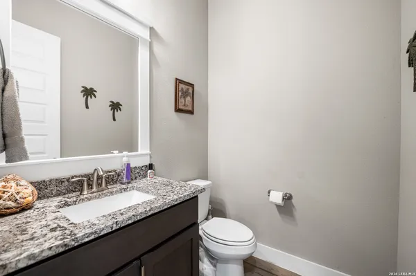 a bathroom with a granite countertop sink mirror and a shower