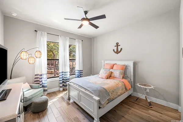 a bedroom with a bed couch and a window