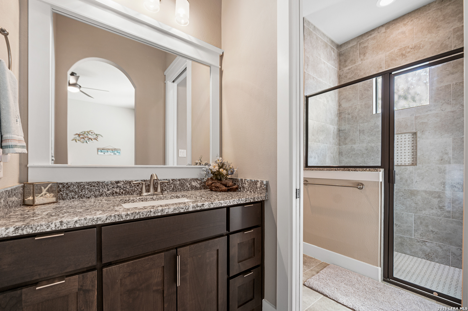 407 Havasu Spring Branch, TX 78070 - Photo 43 of 70 a bathroom with a granite countertop sink mirror and a shower