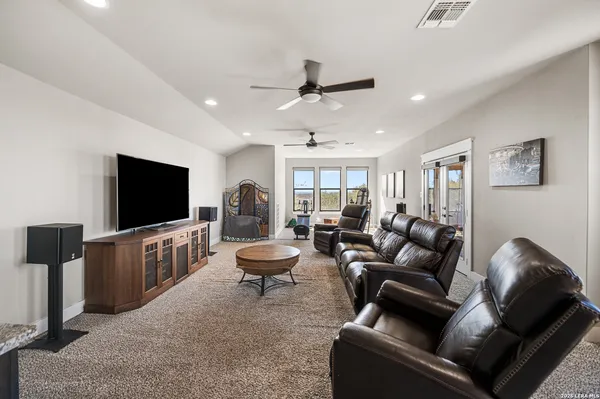 an aerial view of residential houses with outdoor space and trees