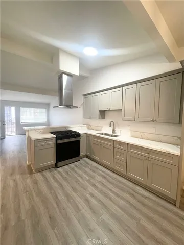 a large kitchen with a white stove top oven and sink