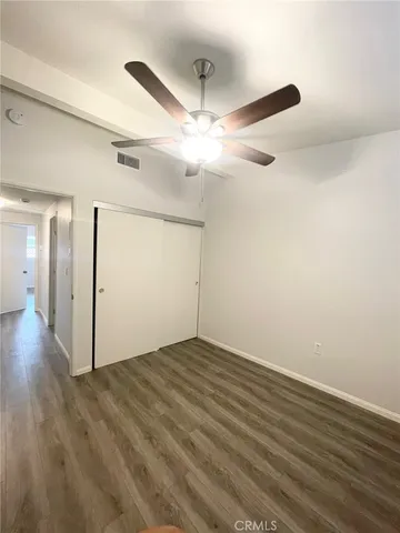 a view of an empty room and wooden floor