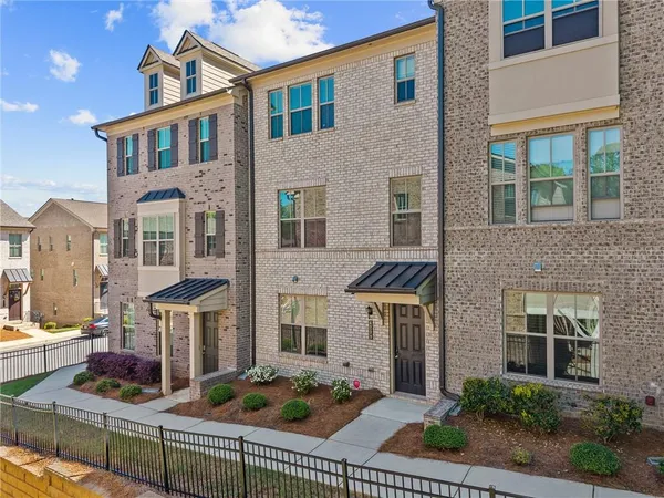 front view of a brick house with large windows
