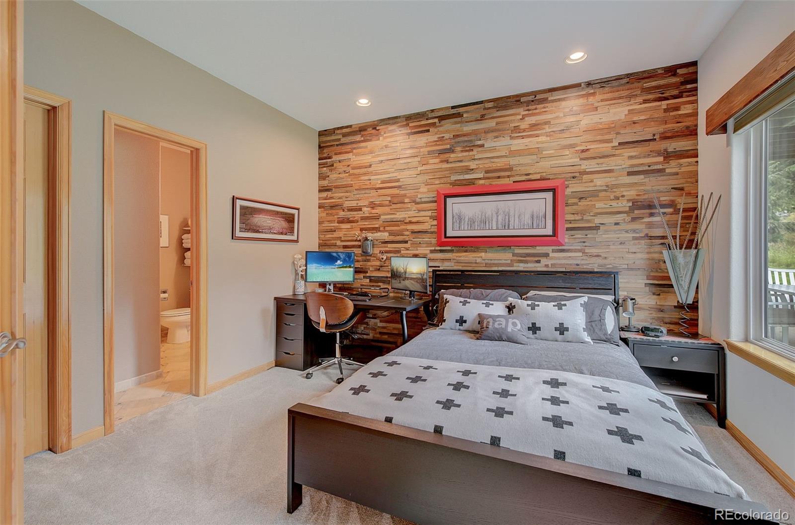 665 Trailside Drive Golden, CO 80401 - Photo 16 of 40 a bedroom with a bed a couch and a window