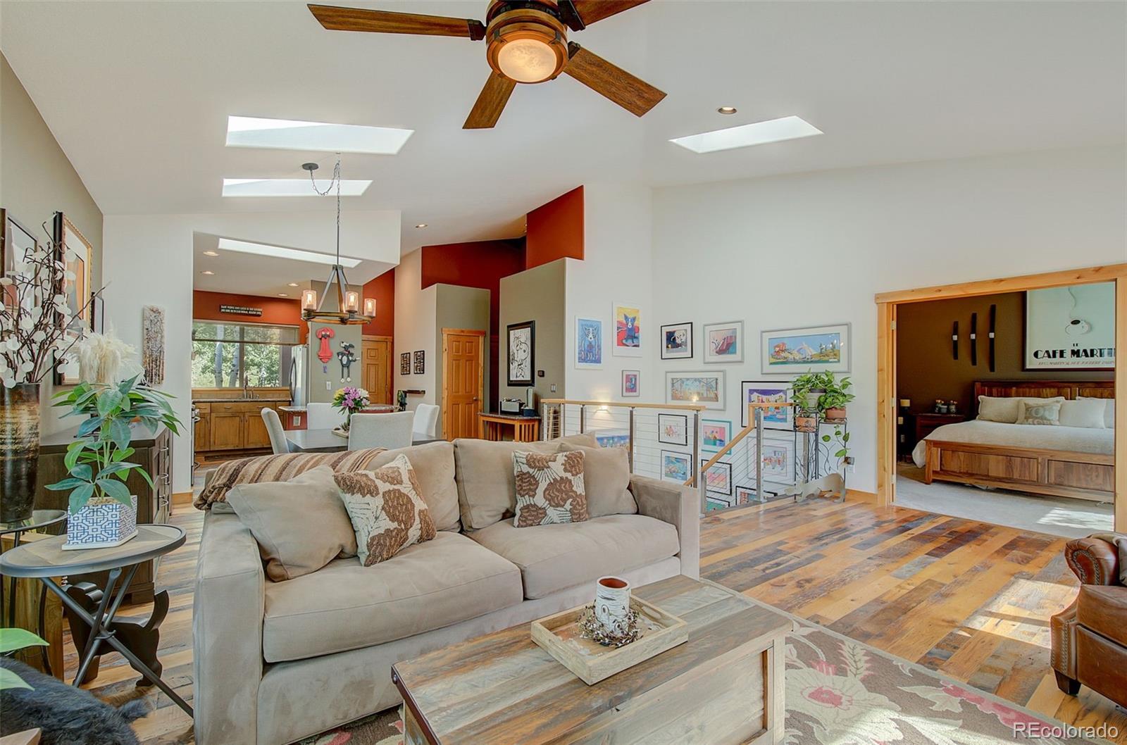 665 Trailside Drive Golden, CO 80401 - Photo 2 of 40 a living room with furniture kitchen view and a chandelier