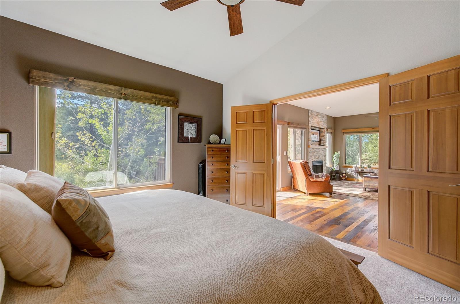 665 Trailside Drive Golden, CO 80401 - Photo 21 of 40 a large bedroom with a bed and large window
