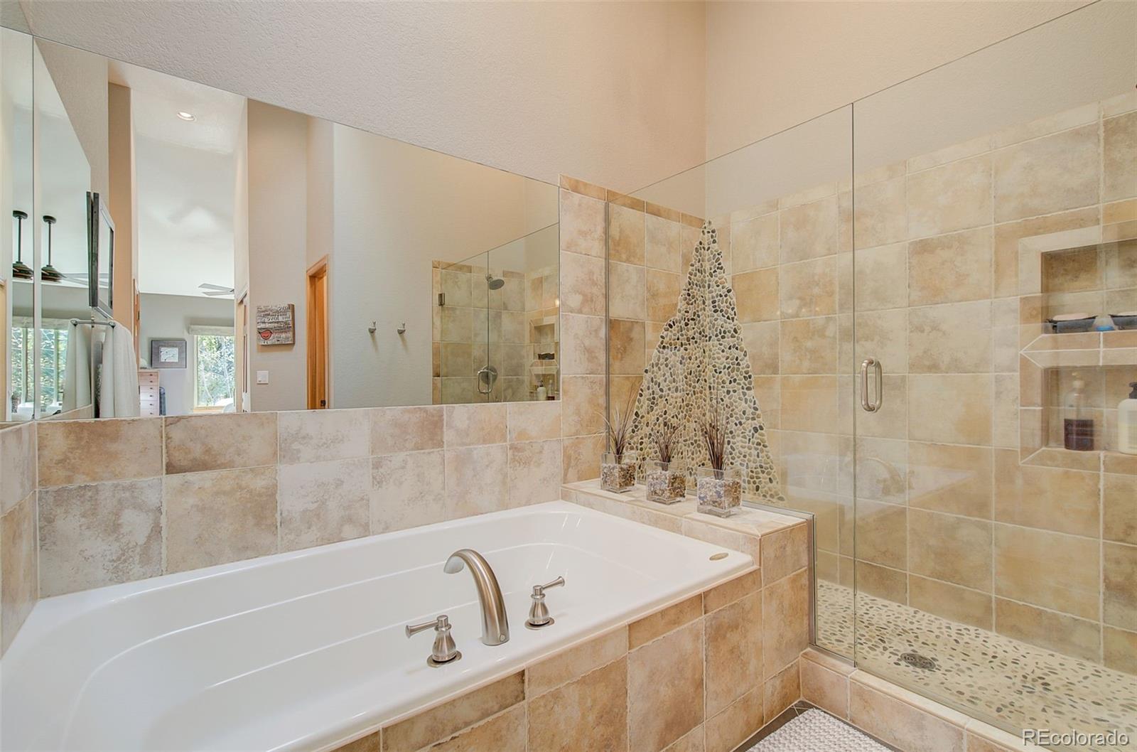 665 Trailside Drive Golden, CO 80401 - Photo 23 of 40 a bathroom with a bathtub and shower