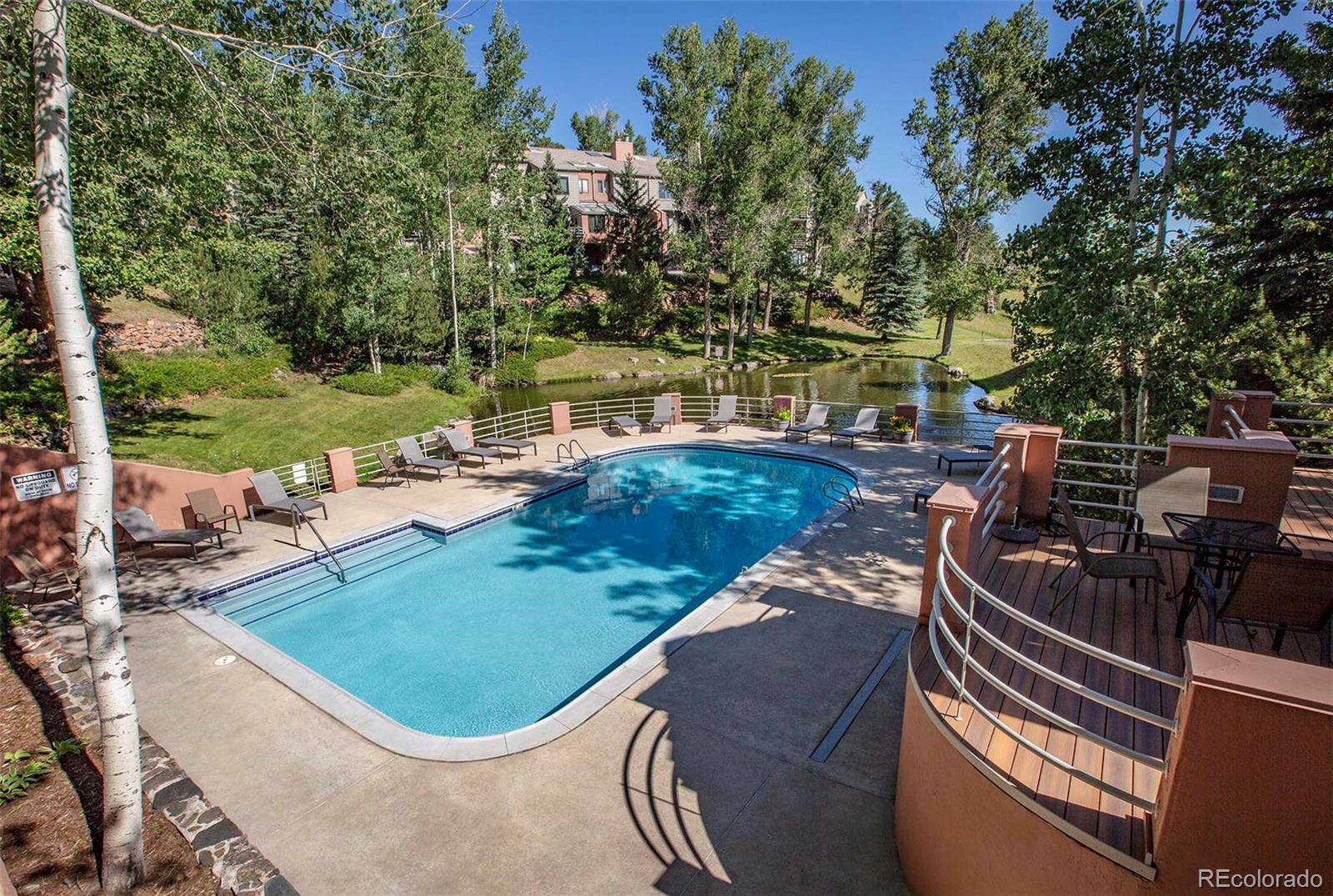 665 Trailside Drive Golden, CO 80401 - Photo 37 of 40 a view of a swimming pool with lawn chairs and a fire pit