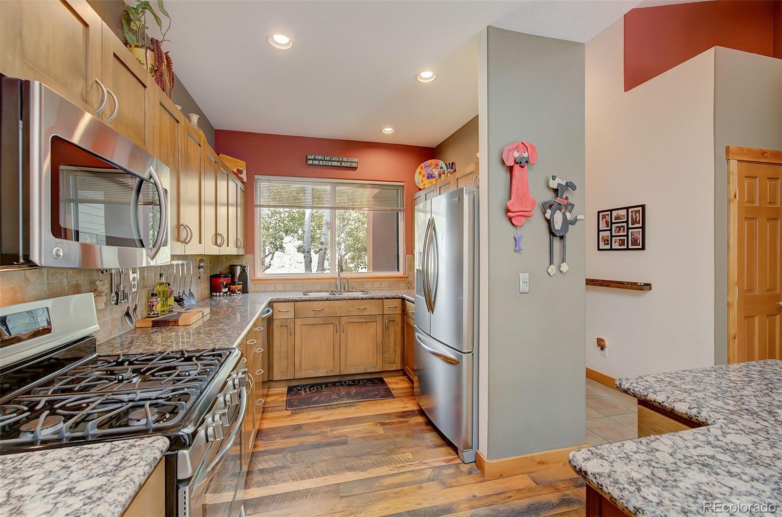 665 Trailside Drive Golden, CO 80401 - Photo 7 of 40 a kitchen with stainless steel appliances granite countertop a refrigerator and a stove