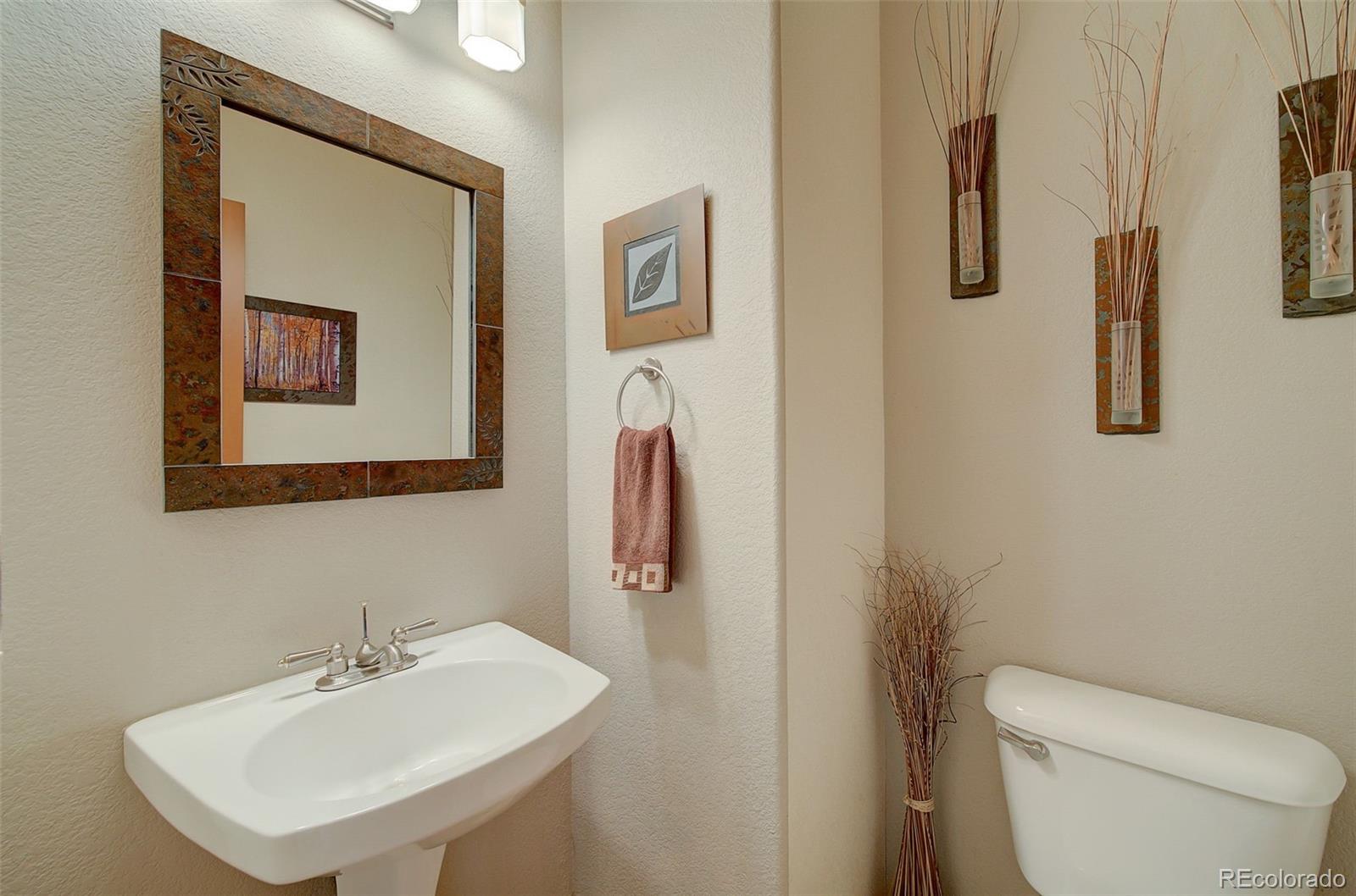 665 Trailside Drive Golden, CO 80401 - Photo 9 of 40 a bathroom with a toilet sink and mirror