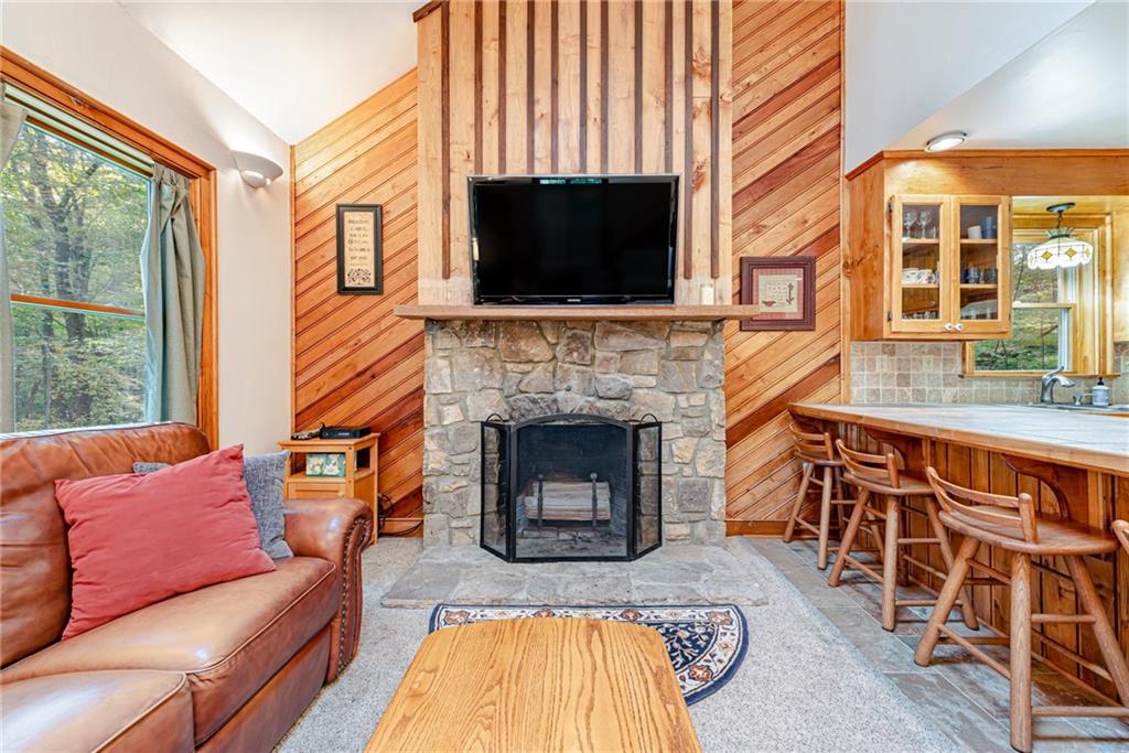 508 Forest Road Acme, PA 15610 - Photo 11 of 29 a living room with furniture a flat screen tv and a fireplace