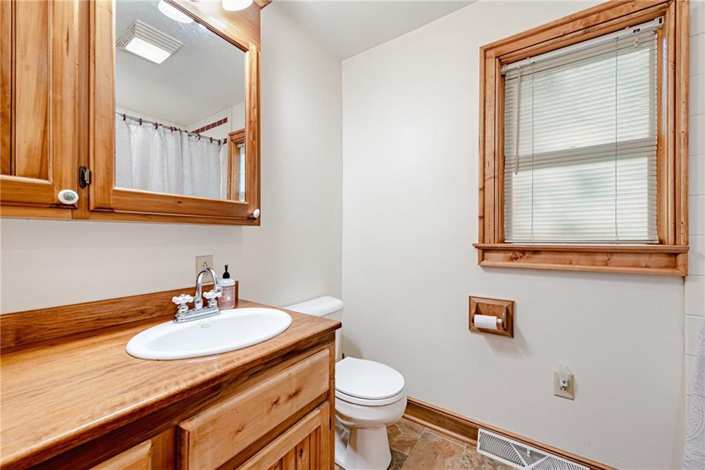508 Forest Road Acme, PA 15610 - Photo 17 of 29 a bathroom with a sink a toilet and mirror