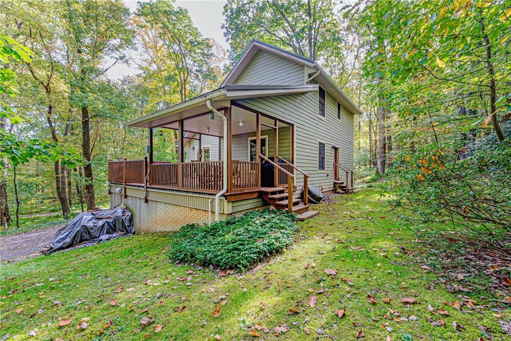 508 Forest Road Acme, PA 15610 - Photo 23 of 29 a backyard of a house with wooden fence and large trees