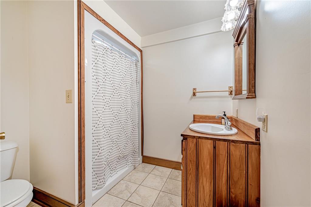 508 Forest Road Acme, PA 15610 - Photo 6 of 29 a view of bathroom with a sink a toilet and a mirror