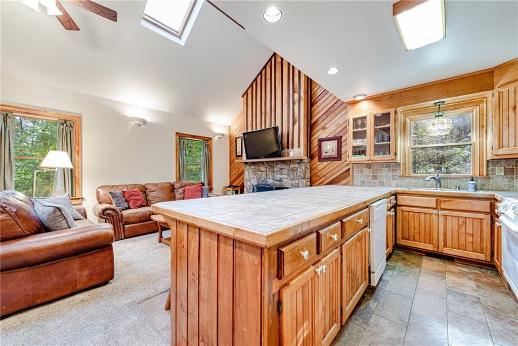 508 Forest Road Acme, PA 15610 - Photo 7 of 29 a kitchen that has a lot of cabinets a sink and a wooden floor