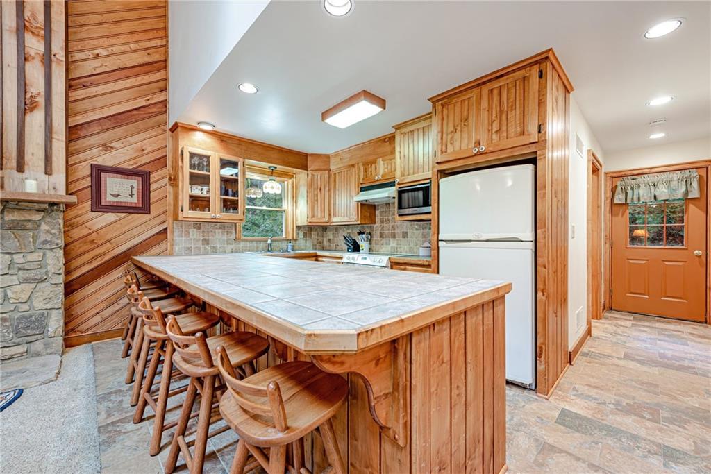 508 Forest Road Acme, PA 15610 - Photo 8 of 29 a kitchen with stainless steel appliances granite countertop a table chairs sink and cabinets