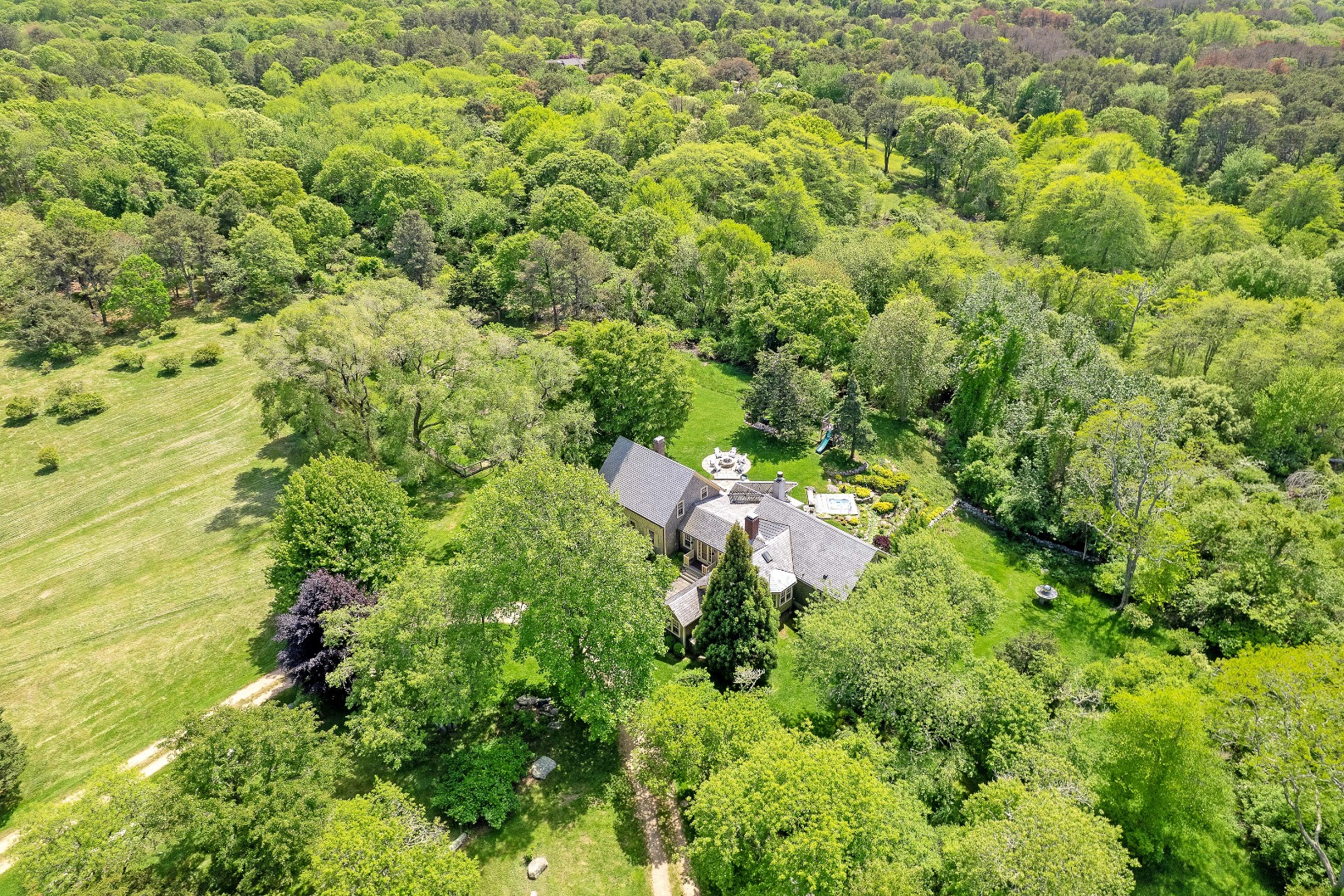 122 Old Farm Road Chilmark, MA 02535 - Photo 2 of 36 an aerial view of residential houses with outdoor space and trees