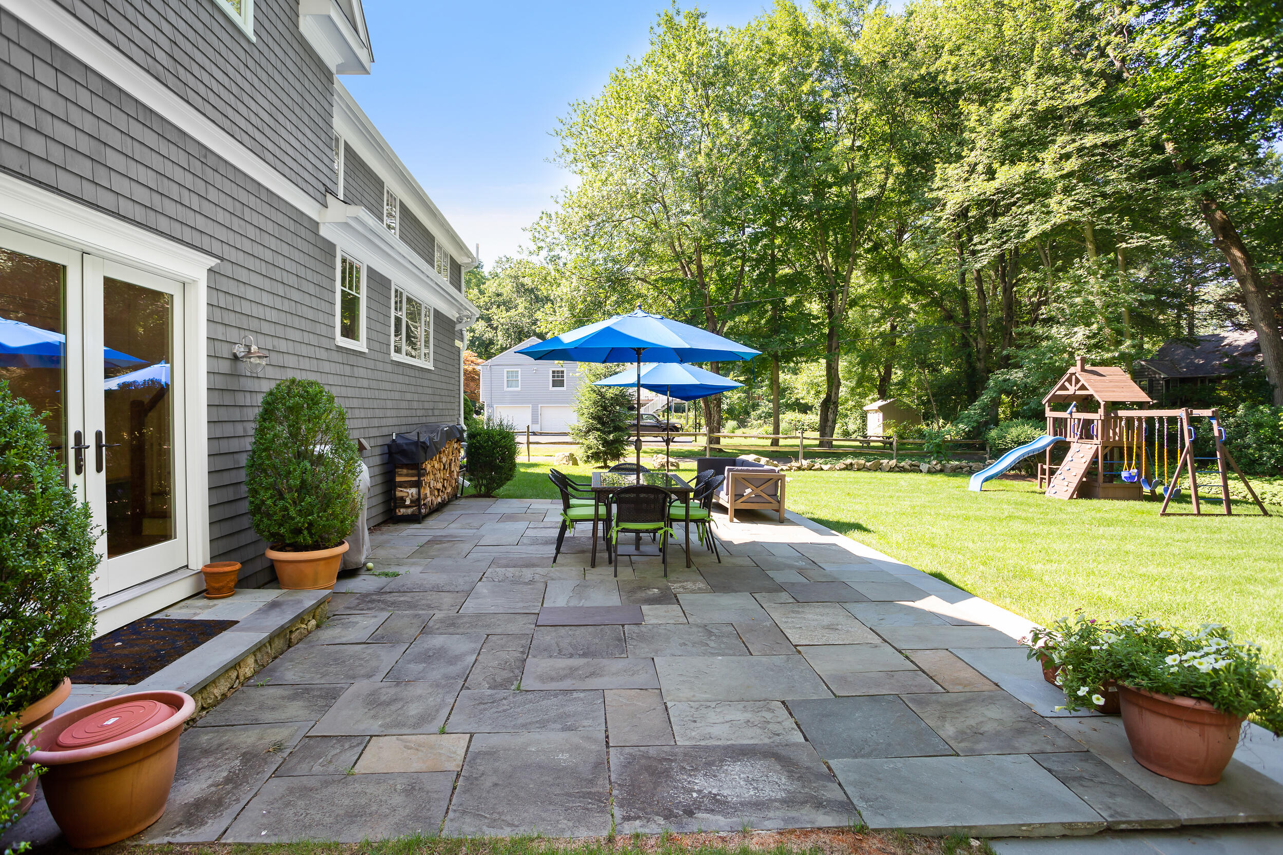 21 Ledge Road Norwalk, CT 06853 - Photo 25 of 32 a view of a patio with a table and chairs under an umbrella