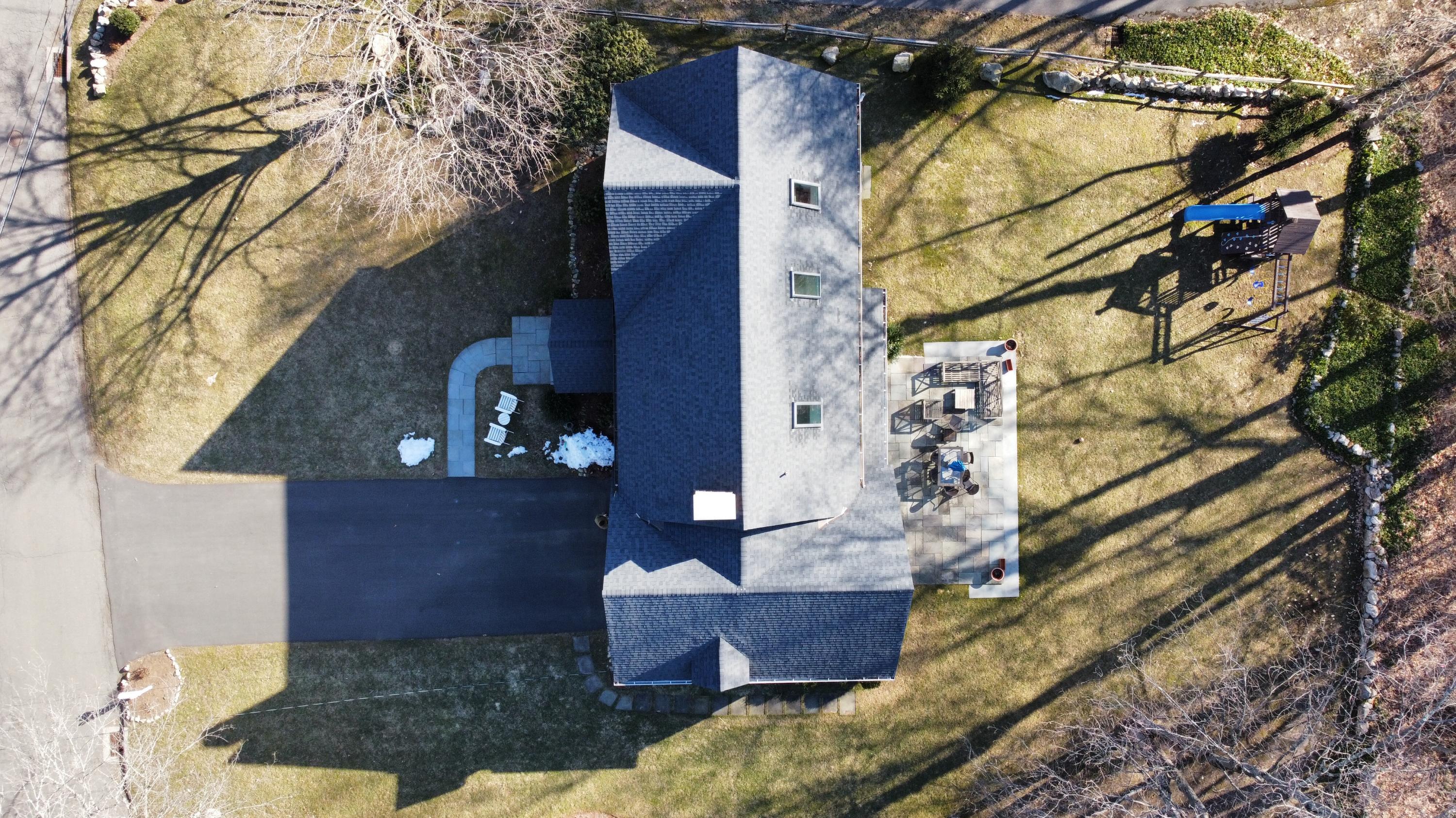 21 Ledge Road Norwalk, CT 06853 - Photo 28 of 32 a view of brick house with a small yard and wooden fence