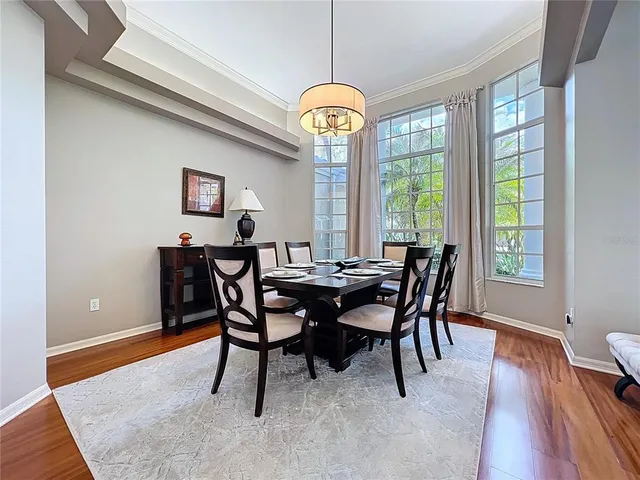 a dining room with a table and chairs