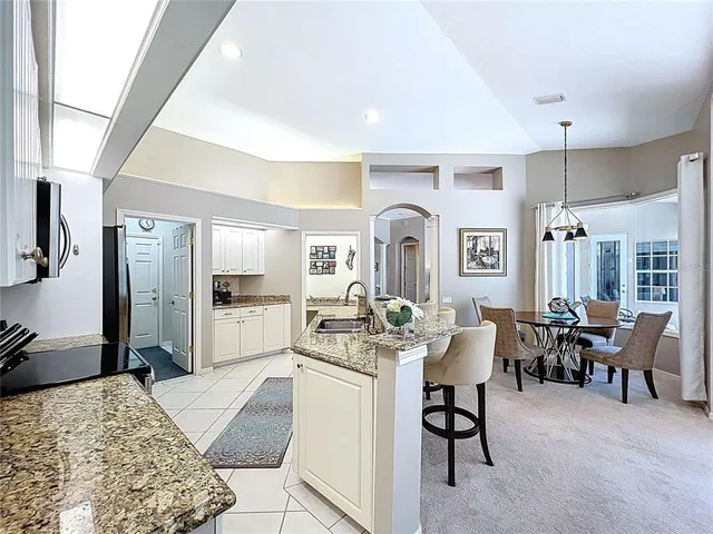 a spacious bedroom with a bed and a chandelier